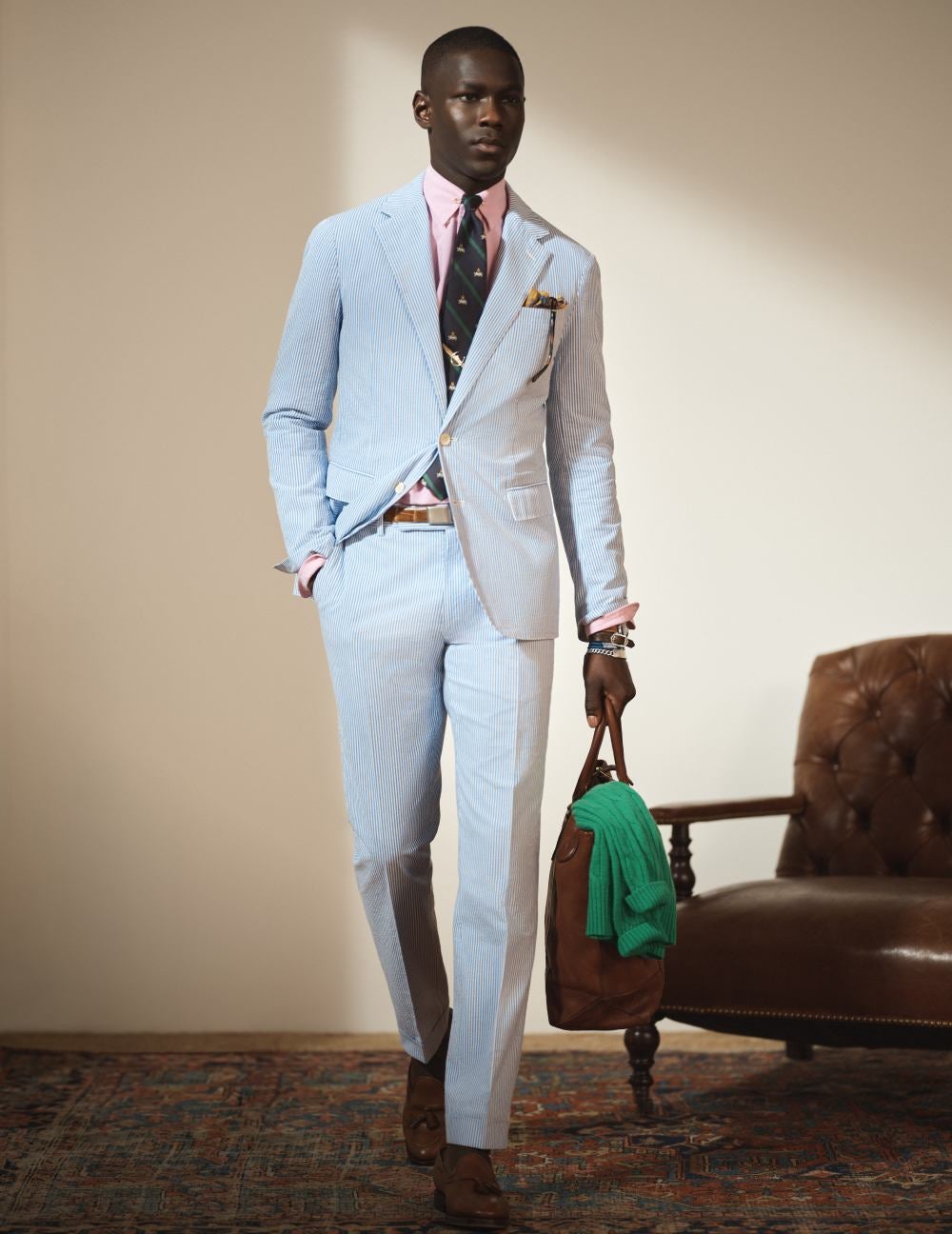 Man wears a light-blue suit and pants.