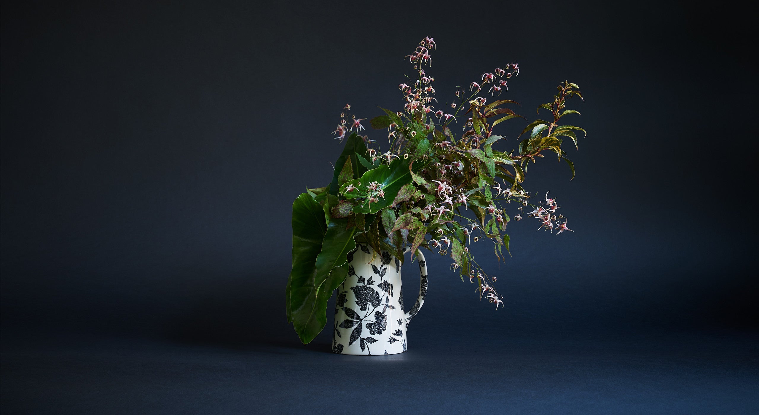 &ldquo;This is a perfect choice if somebody was looking to create an arrangement with a woodland feel. At the heart of this one is epimedium, which is actually a very common garden flower that has beautiful foliage and a short blooming season in the spring. It&rsquo;s all about the texture and speckling, which is something I come back to again and again. With everything I do, I want people to have to look a little harder than they usually might. This also has Leucothoe&mdash;a common shrub that&rsquo;s very hardy and often overlooked&mdash;as well as philodendron, a houseplant that&rsquo;s super long-lasting in the vase. I&rsquo;ve tried to transform them from appearing waxy and tropical to something you might discover in a wetland bog.&rdquo;