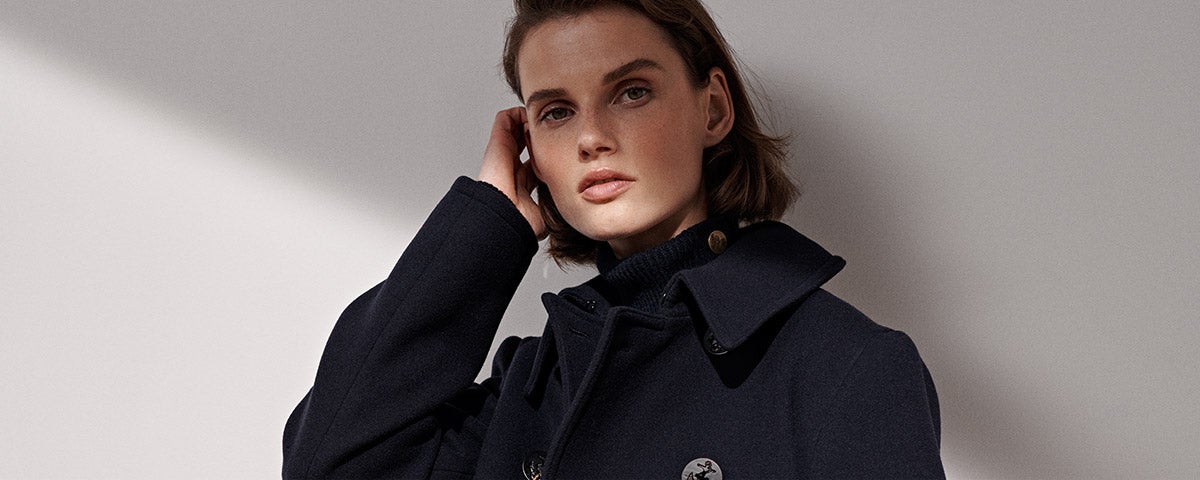 Woman in peacoat with anchor buttons