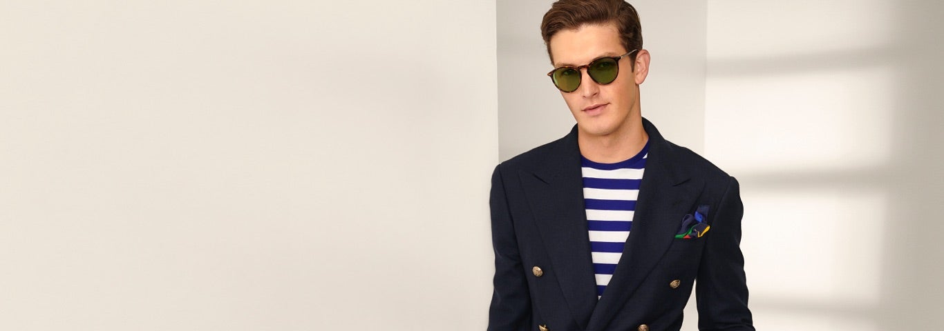 Man in navy blazer layered over blue & white striped T-shirt