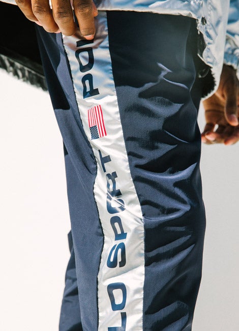 Close-up of navy joggers with metallic Polo Sport trim