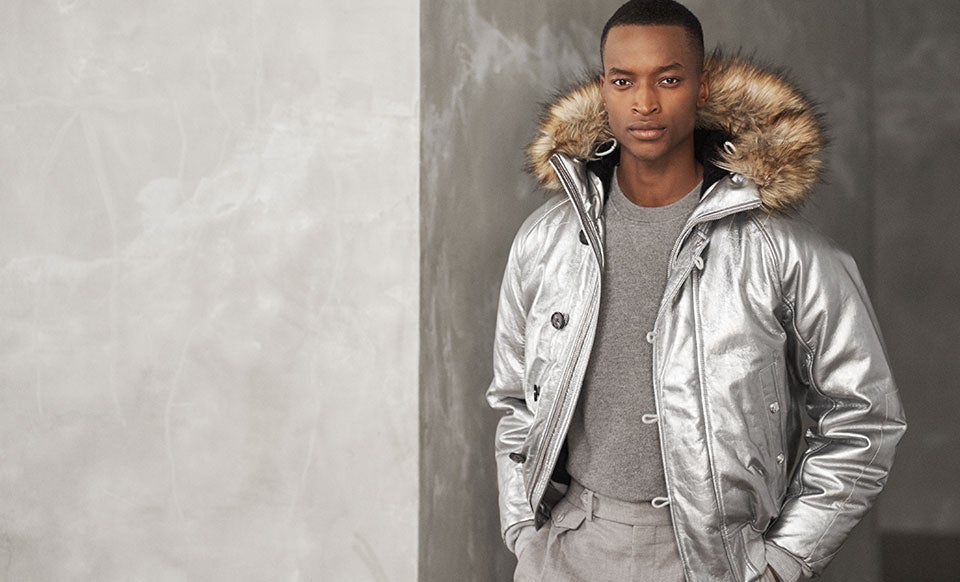 Man in silver jacket with faux-fur-trim hood