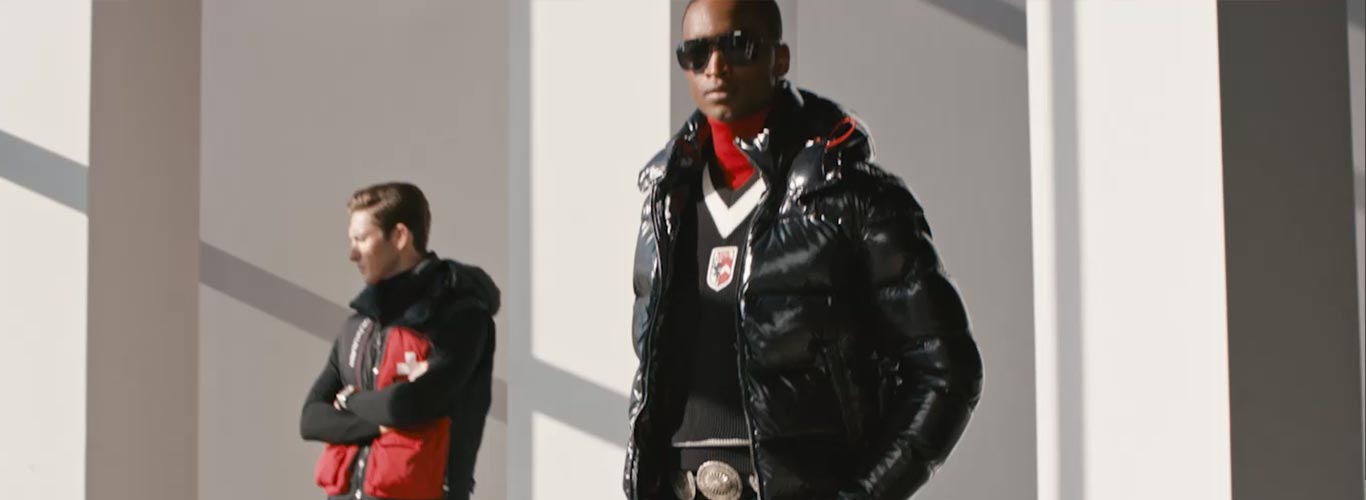 Video of man in high-shine black quilted down coat