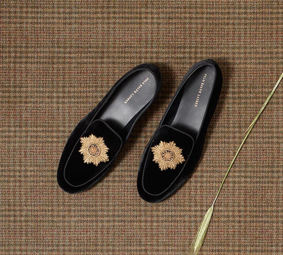 Black suede loafers with gold accent at toe