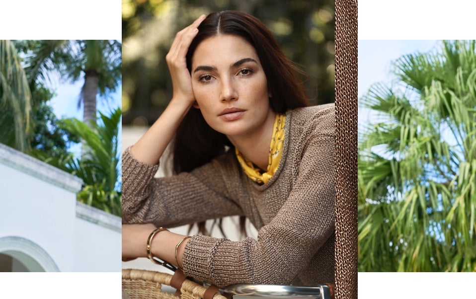 Model wears lightweight knit brown sweater.